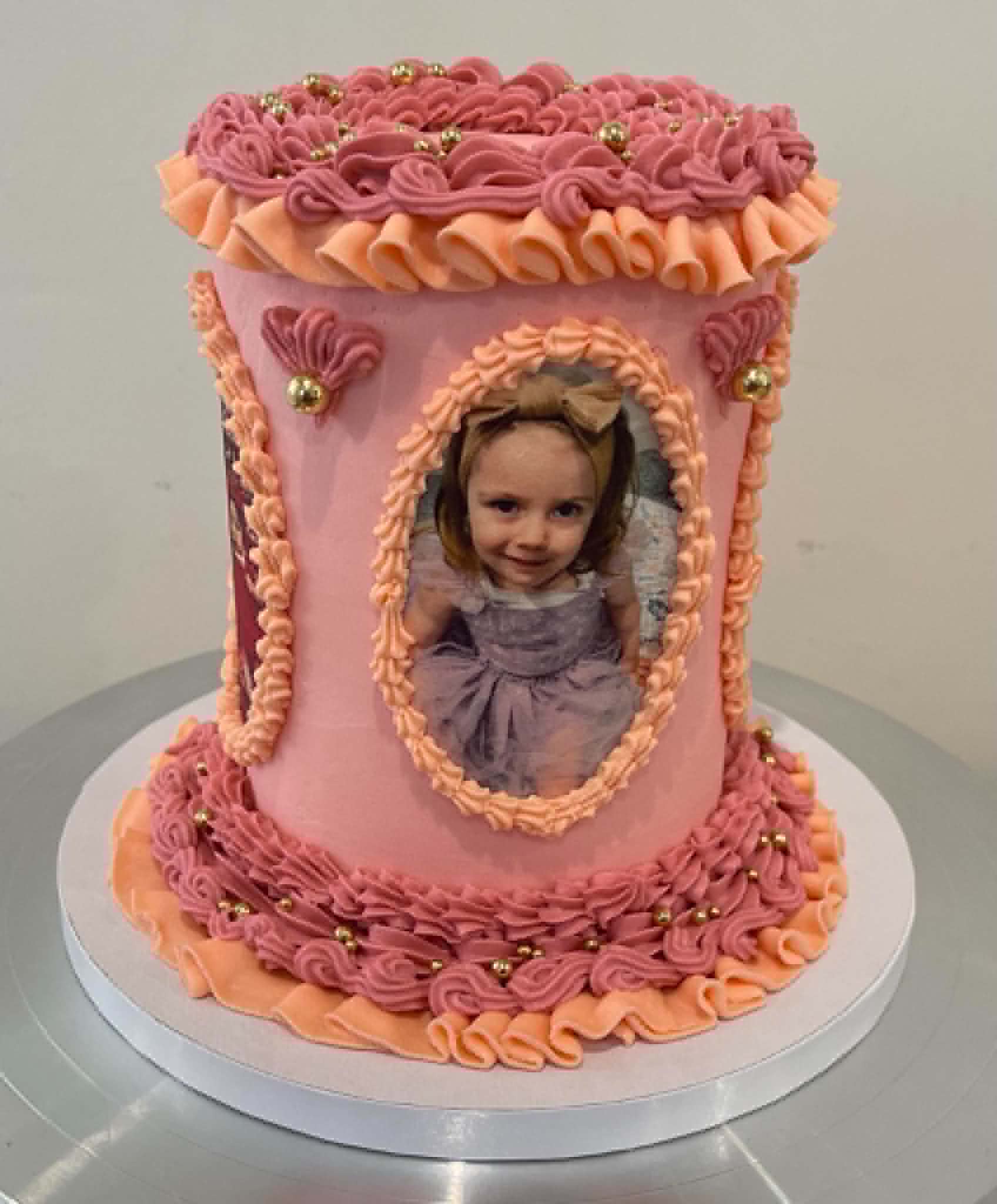 Pink vintage piped cake with an edible photo portrait frame